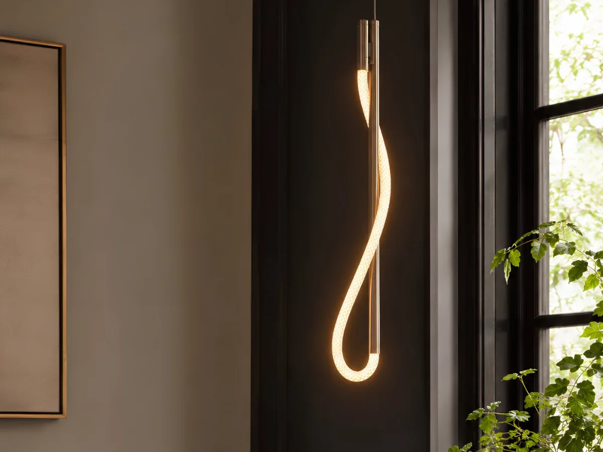 Eden pendant in polished nickel — illuminated cord looped around a slim vertical stem